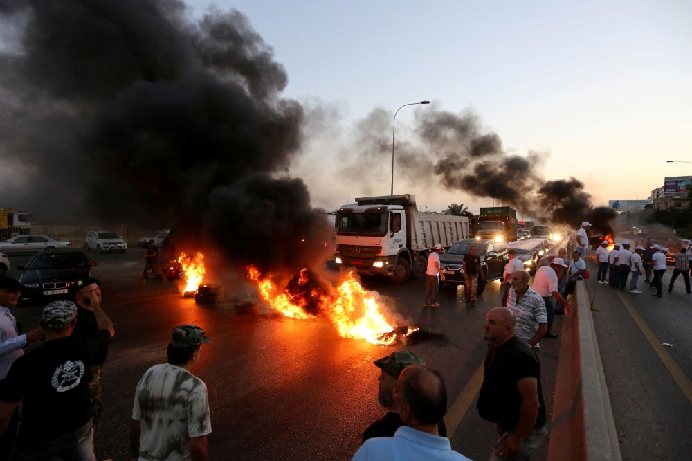 Lebanese army veterans burn tires during a protest over a state budget that includes a provision taxing their pensions, in Naameh, south of Beirut, Lebanon, on Thursday. — Reuters