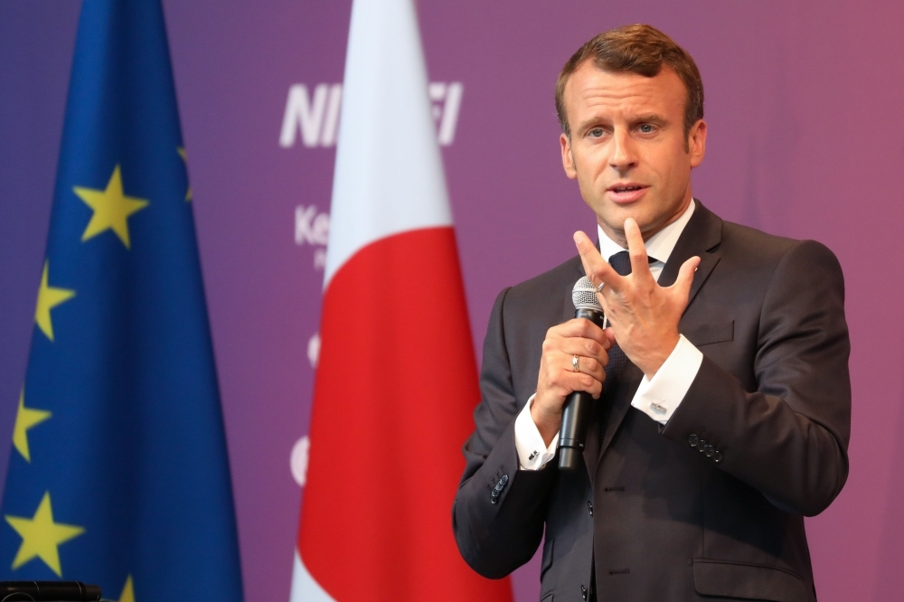 French President Emmanuel Macron delivers a speech during his visit to Miraikan innovation museum in Tokyo on Thursday. — AFP