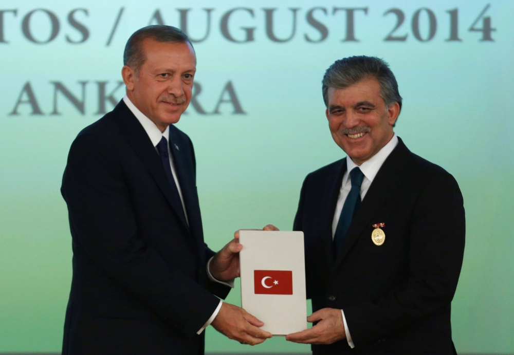 Turkey's new President Tayyip Erdogan, left, and outgoing President Abdullah Gul, attend a handover ceremony at the Presidential Palace of Cankaya in Ankara in this Aug. 28, 2014 file photo. — Reuters