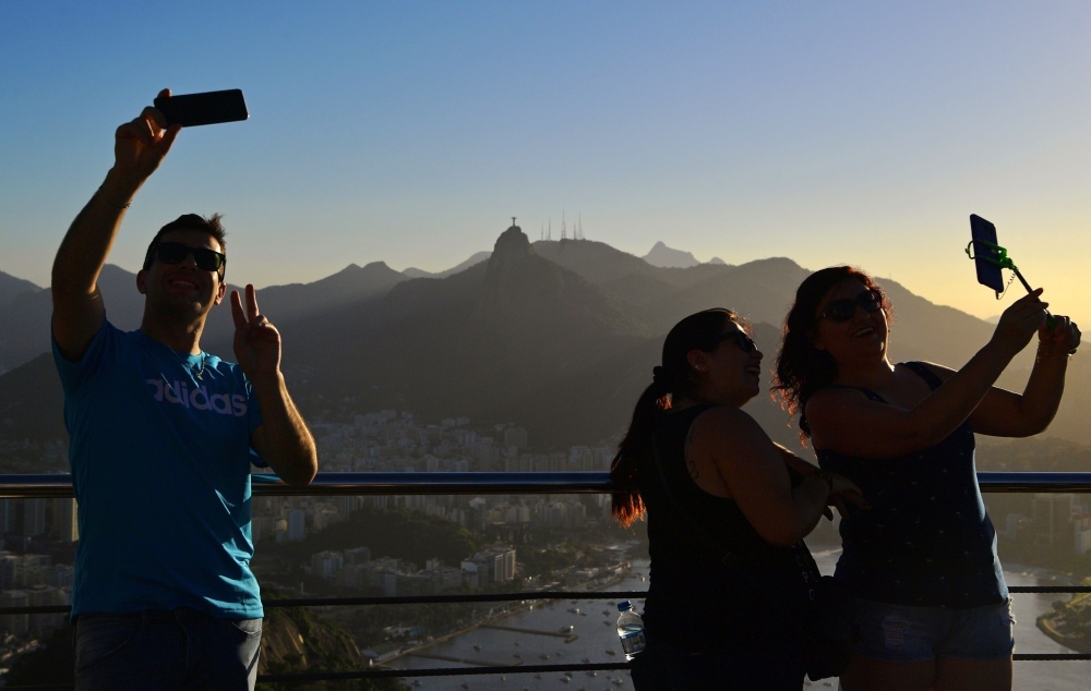 Tourists take selfies at Sugarloaf Hill in Rio de Janeiro, Brazil, in this June 7, 2019 file photo. — AFP