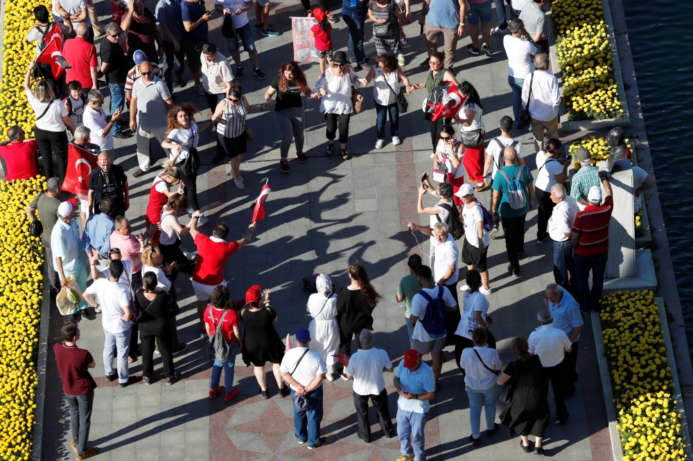 Supporters of Mayor of Istanbul Ekrem Imamoglu of the main opposition Republican People's Party (CHP) dance outside the City Hall in Istanbul, Turkey, on Thursday. — Reuters