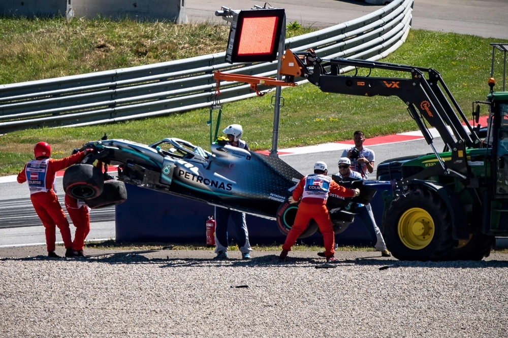 Mercedes' Finnish driver Valtteri Bottas walks to his garage during the first practice session of the Austrian Formula One Grand Prix at the Red Bull circuit in Spielberg, Austria on Friday. — AFP