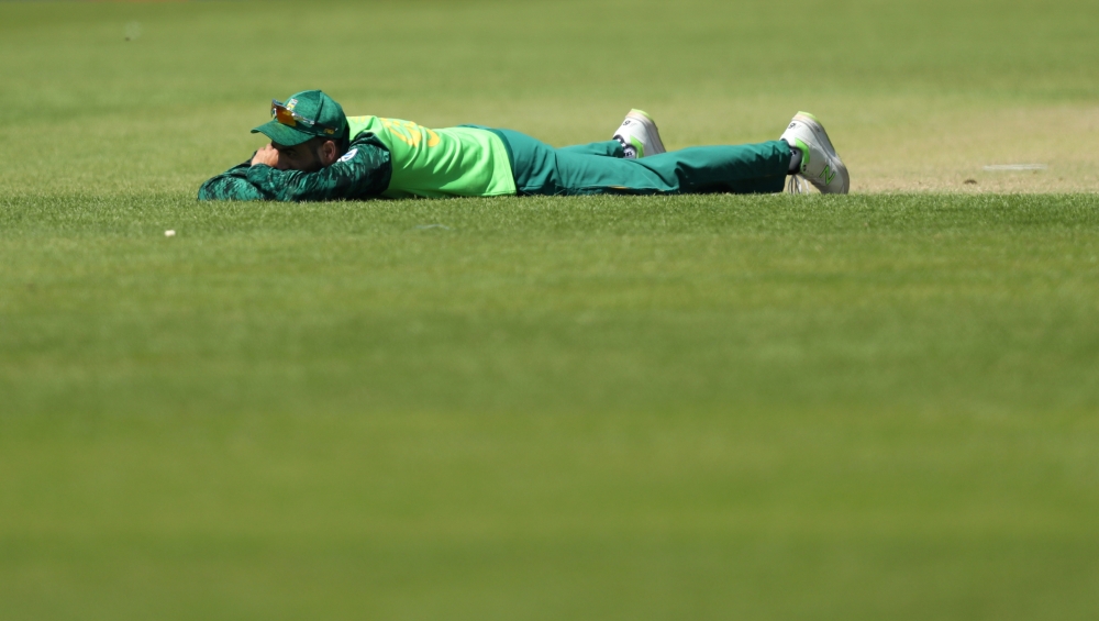 The umpire, Sri Lanka and South Africa players lie on the ground to avoid bees during the ICC Cricket World Cup match at the  Emirates Riverside, Chester-Le-Street, Britain on Friday. — Reuters