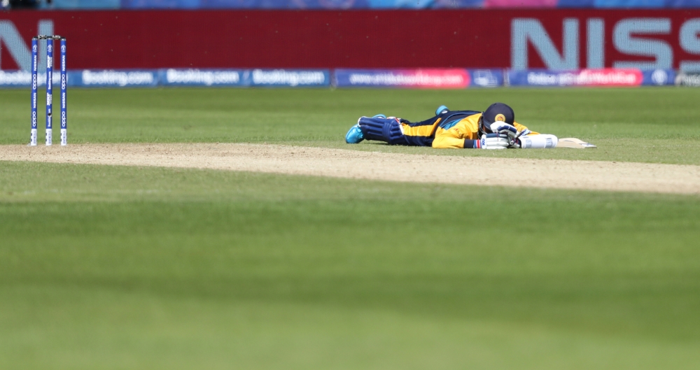 The umpire, Sri Lanka and South Africa players lie on the ground to avoid bees during the ICC Cricket World Cup match at the  Emirates Riverside, Chester-Le-Street, Britain on Friday. — Reuters