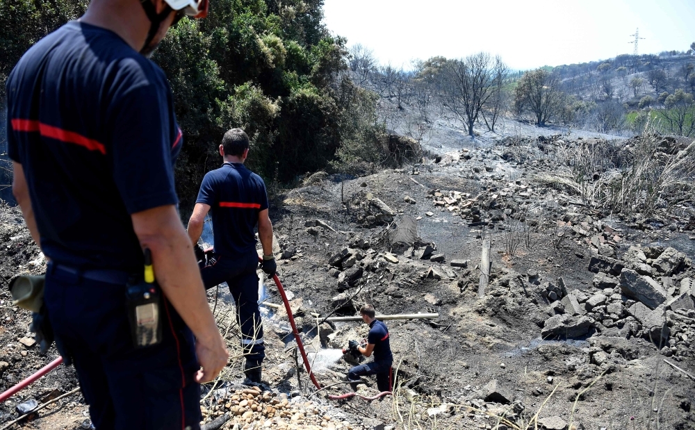 French firefighters extinguish a fire after brushfire hit the countryside around Saint Gilles, on in the south of France, Saturday. — AFP











picture taken June 29, 2019 in Saint Gilles in the South of France. the fires that began on June 28, 2109 burned 620 hectares and 710 firefighters engaged / AFP / SYLVAIN THOMAS