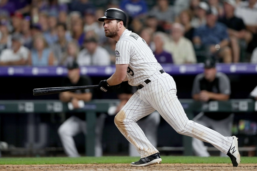 Daniel Murphy No. 9 of the Colorado Rockies hits a RBI sacrifice fly in the eighth inning against the Los Angeles Dodgers at Coors Field on Friday in Denver, Colorado. — AFP