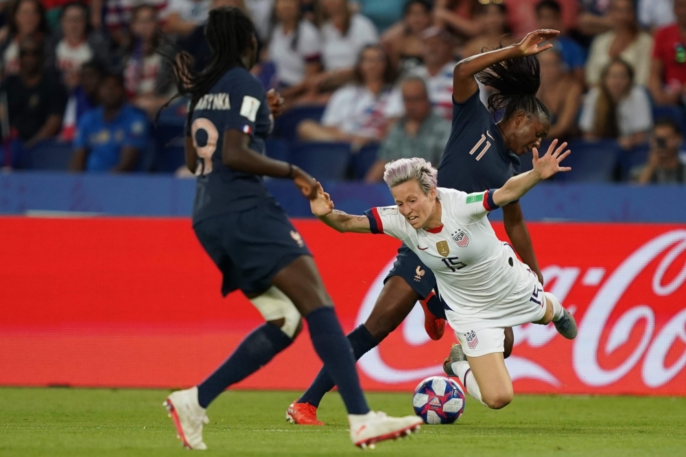 United States' forward Megan Rapinoe (C) vies with France's forward Kadidiatou Diani (R) during the France 2019 Women's World Cup quarterfinal football match between France and USA, on Friday, at the Parc des Princes stadium in Paris. — AFP