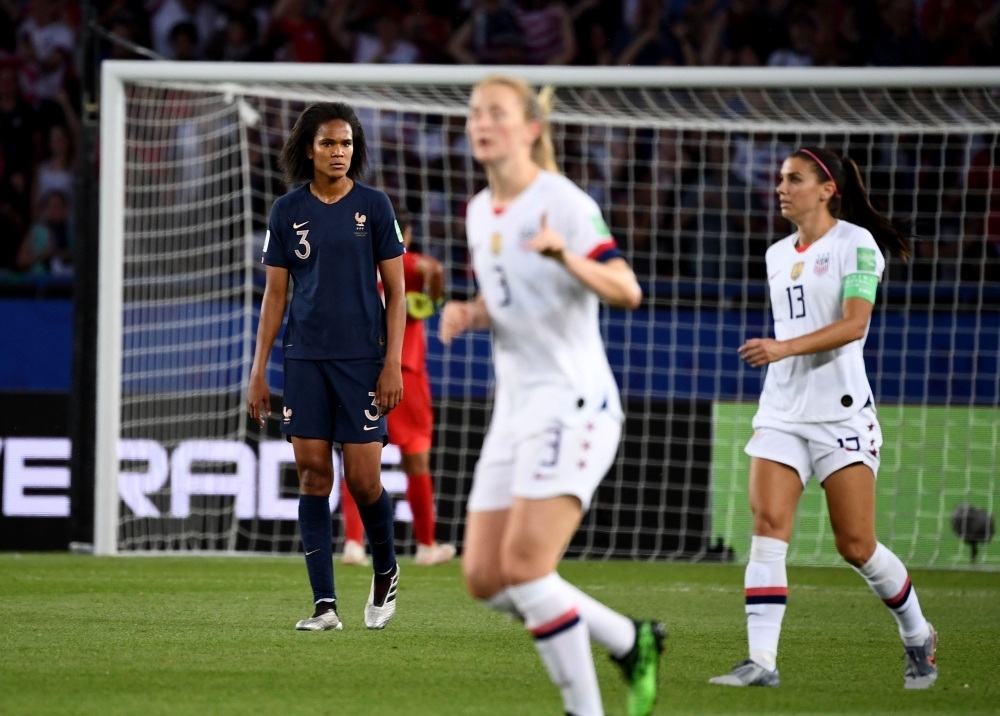 United States' forward Megan Rapinoe (C) vies with France's forward Kadidiatou Diani (R) during the France 2019 Women's World Cup quarterfinal football match between France and USA, on Friday, at the Parc des Princes stadium in Paris. — AFP