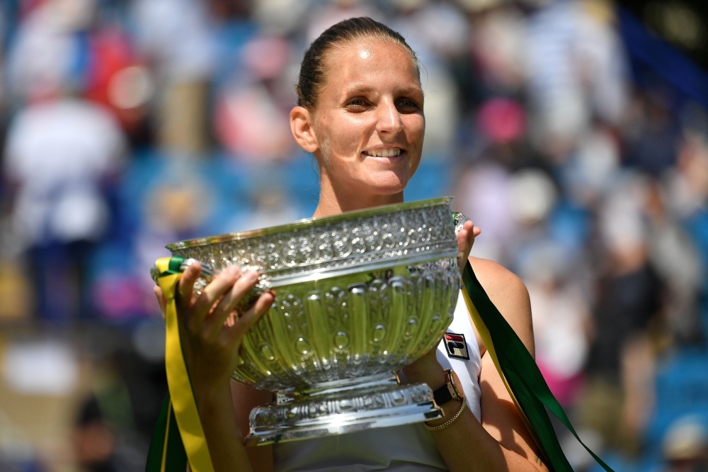 Czech Republic's Karolina Pliskova holds aloft the winners trophy as she celebrates winning against Germany's Angelique Kerber during their women's singles final match at the WTA Nature Valley International tennis tournament in Eastbourne, southern England on Saturday.  Pliskova won the match 6-1, 6-4. — AFP