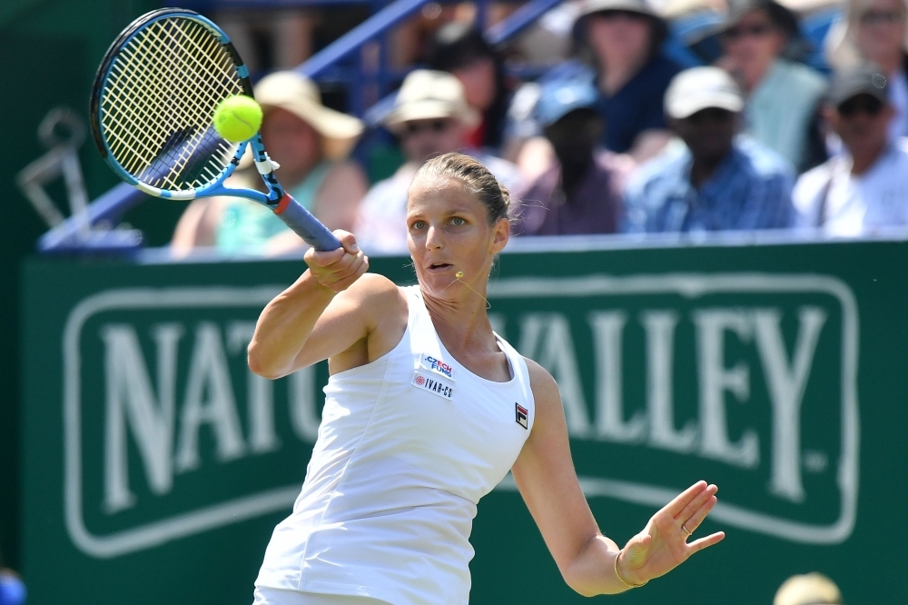 Czech Republic's Karolina Pliskova holds aloft the winners trophy as she celebrates winning against Germany's Angelique Kerber during their women's singles final match at the WTA Nature Valley International tennis tournament in Eastbourne, southern England on Saturday.  Pliskova won the match 6-1, 6-4. — AFP