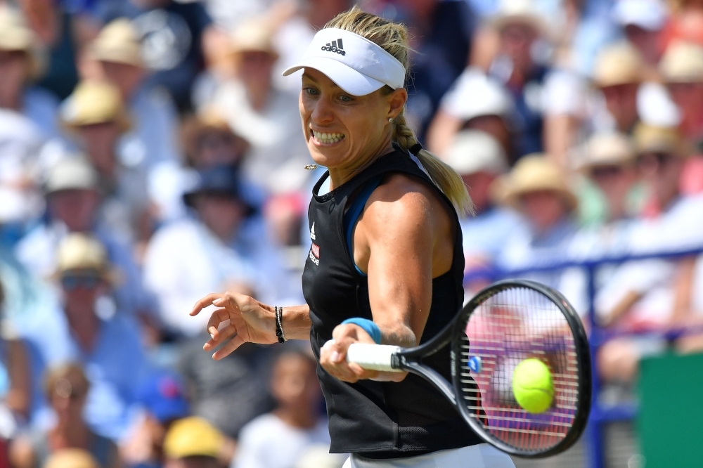 Czech Republic's Karolina Pliskova holds aloft the winners trophy as she celebrates winning against Germany's Angelique Kerber during their women's singles final match at the WTA Nature Valley International tennis tournament in Eastbourne, southern England on Saturday.  Pliskova won the match 6-1, 6-4. — AFP