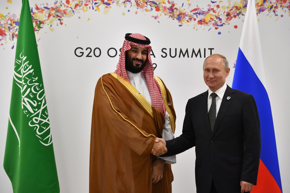 Crown Prince Muhammad Bin Salman, deputy premier and minister of defense, shakes hands with Russia's President Vladimir Putin during a meeting on the sidelines of the G20 Summit in Osaka, Japan, Saturday. — Reuters