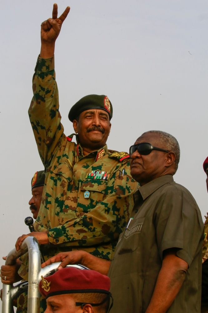 General Abdel Fattah al-Burhan, the head of Sudan's ruling military council, flashes the V sign in Khartoum's twin city of Omdurman on Saturday. -AFP