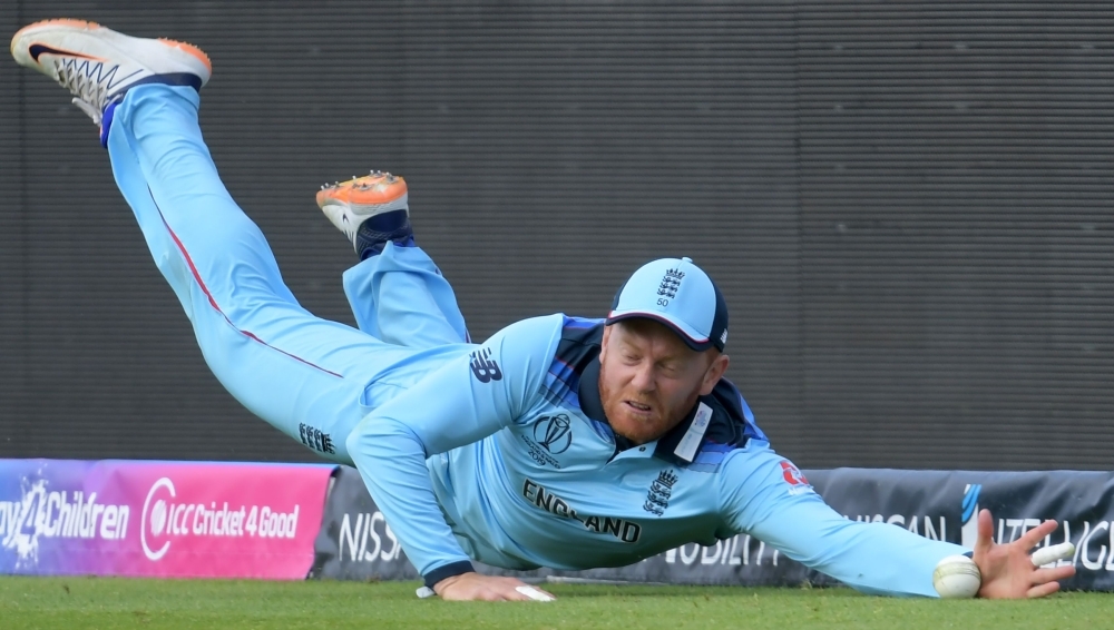 England's Jonny Bairstow dives to field a ball during the 2019 Cricket World Cup group stage match against India at Edgbaston in Birmingham, central England, on Sunday. — AFP