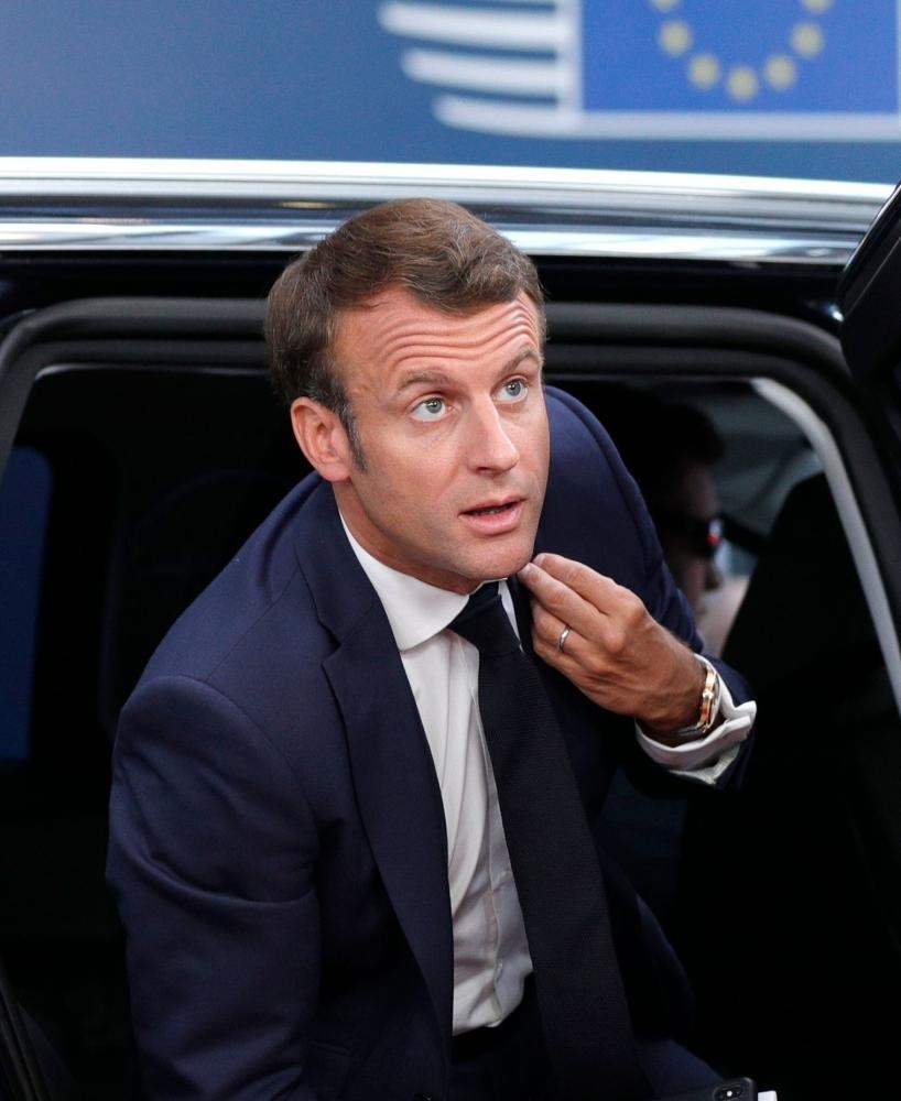French President Emmanuel Macron arrives for the third straight day of a European Union leaders summit in Brussels on Tuesday. — AFP
