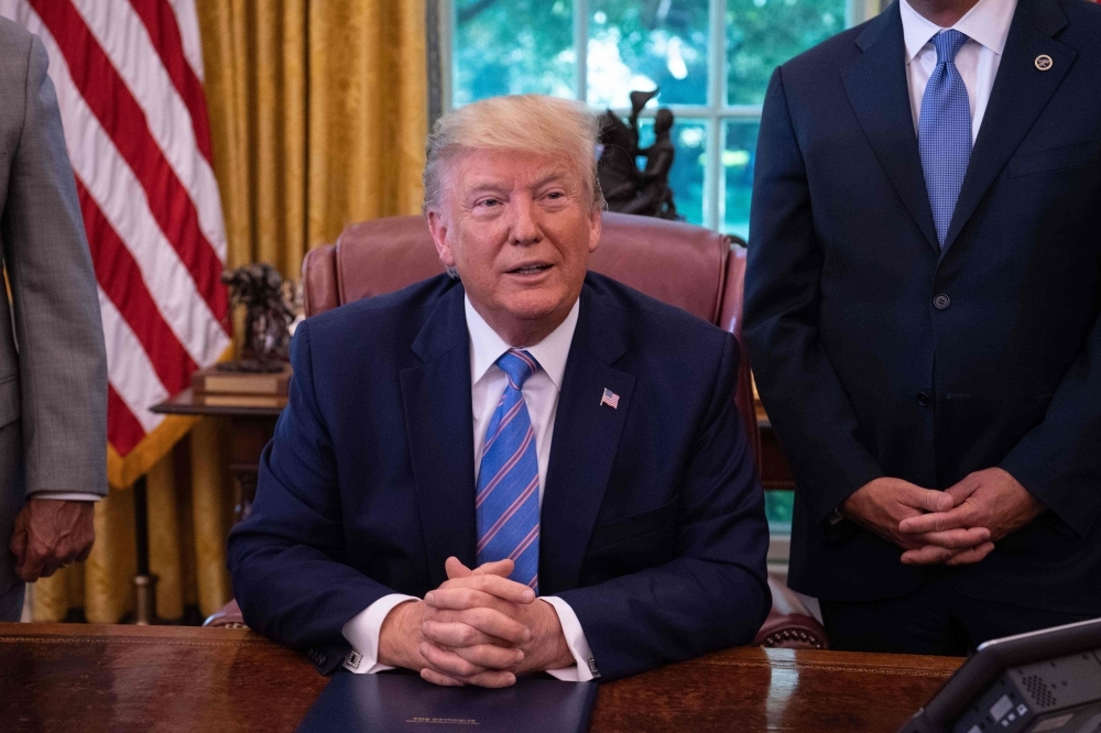 US President Donald Trump speaks to the press after signing a bill for border funding legislation in the Oval Office at the White House in Washington on Monday. — AFP