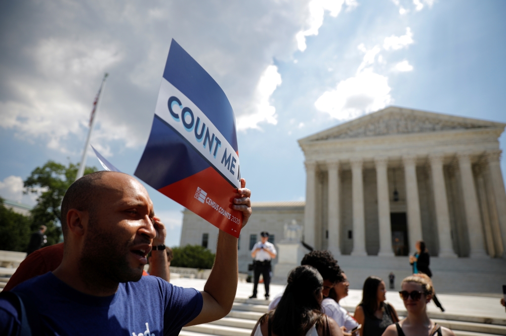 A protester holds a sign outside the US Supreme Court where the court ruled on June 27 that US President Donald Trump's administration did not give an adequate explanation for its plan to add a citizenship question to the 2020 census. -Reuters
