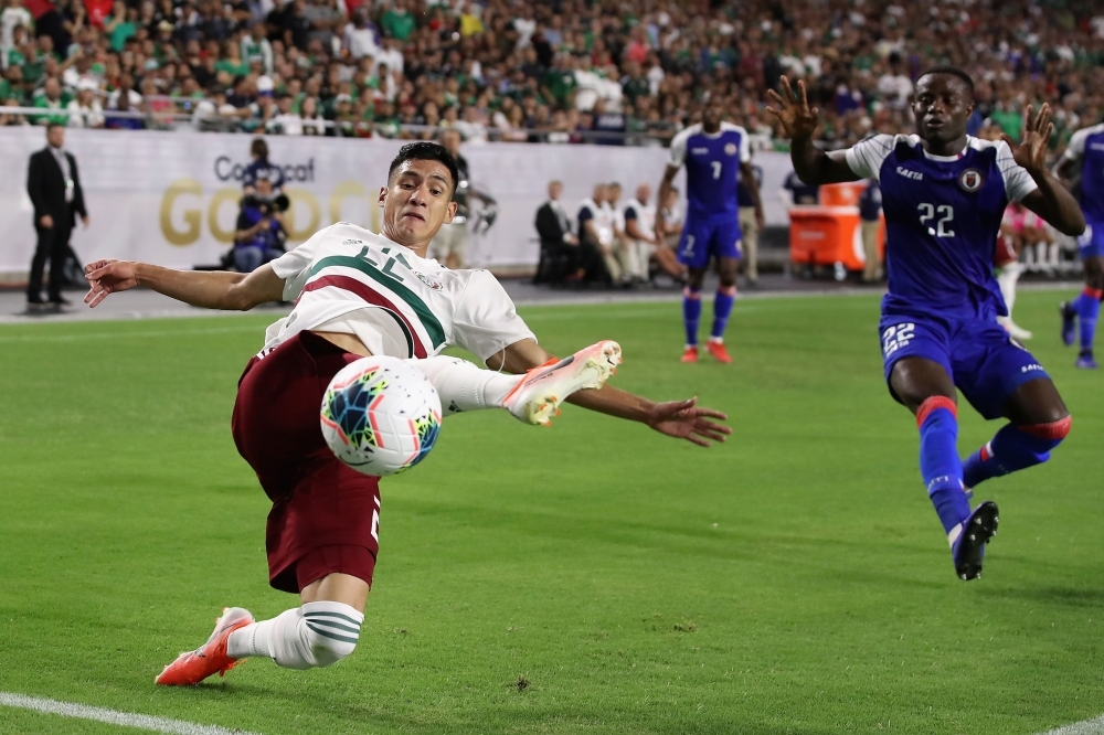 Jorge Sanchez No. 22 of Mexico attempts a shot ahead of Alex Christian No. 22 of Haiti during the second half of the CONCACAF Gold Cup semifinal match at State Farm Stadium on Tuesday in Glendale, Arizona. Mexico defeated Haiti 1-0 in overtime. — AFP