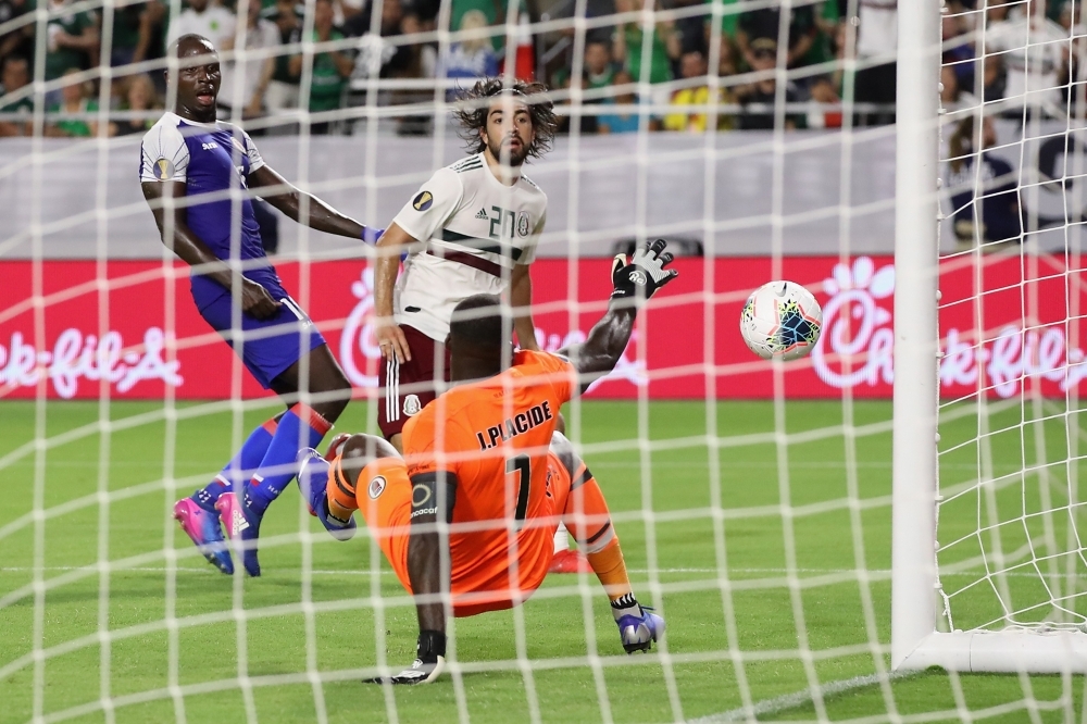 Jorge Sanchez No. 22 of Mexico attempts a shot ahead of Alex Christian No. 22 of Haiti during the second half of the CONCACAF Gold Cup semifinal match at State Farm Stadium on Tuesday in Glendale, Arizona. Mexico defeated Haiti 1-0 in overtime. — AFP