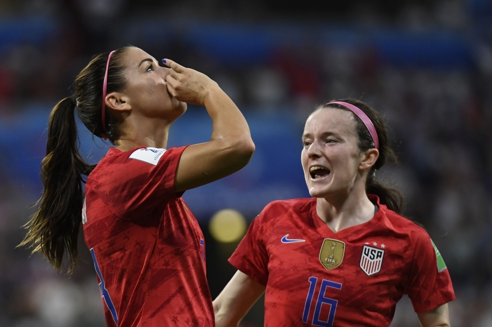 United States' forward Alex Morgan (L) celebrates by sipping a cup of tea after scoring a goal during the France 2019 Women's World Cup semifinal football match against England on Tuesday at the Lyon Satdium in Decines-Charpieu, central-eastern France. — AFP