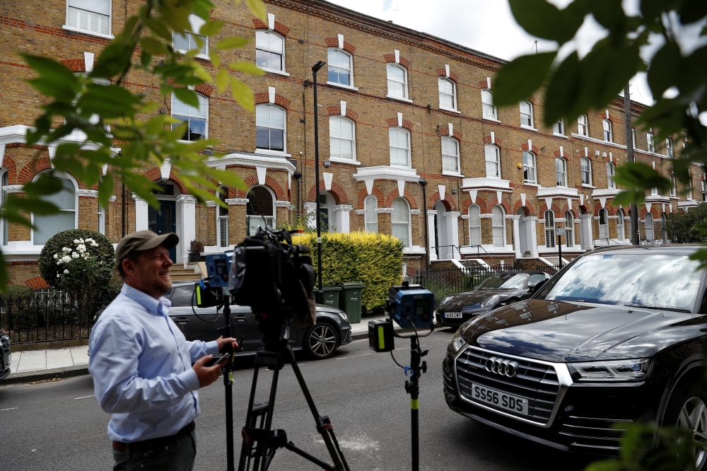 General view outside a house where the body of a suspected stowaway fell into the back garden from a plane flying over southwest London, Britain, on Tuesday. — Reuters