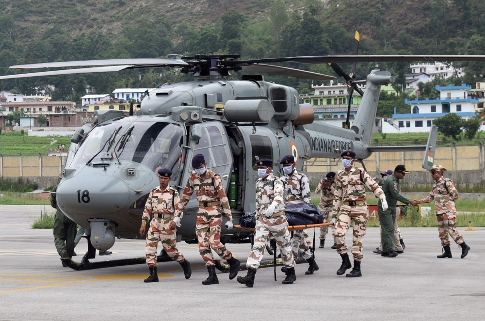 Indo-Tibetan Border Police (ITBP) personnel carry the body of a mountaineer retrieved from Nanda Devi after landing in a helicopter in Pithoragarh in the Indian state of Uttarakhand on Wednesday. — AFP