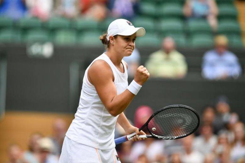 Australia's Ashleigh Barty celebrates beating China's Zheng Saisai during their women's singles first round match at the 2019 Wimbledon Championships on Tuesday. — AFP