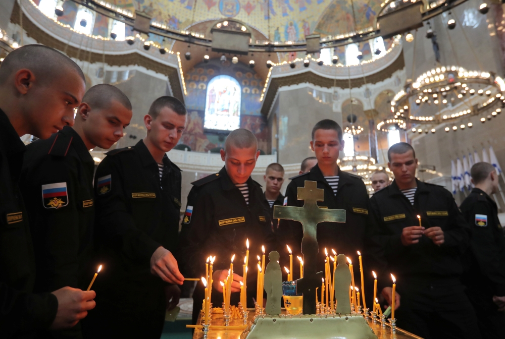 Russian servicemen attend a memorial service for sailors killed in a Russian submarine, which caught fire in the area of the Barents Sea, at the Naval Cathedral of Saint Nicholas in Kronstadt, Russia, on Thursday. — Reuters