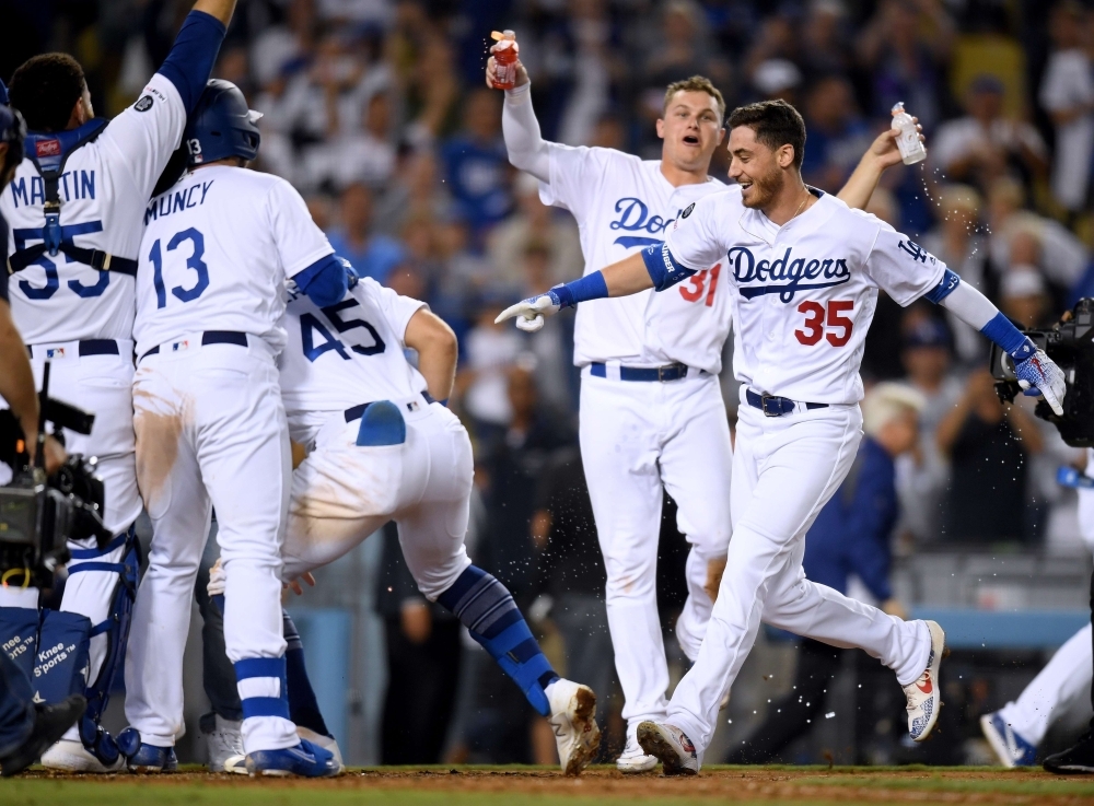 Cody Bellinger No. 35 of the Los Angeles Dodgers celebrates his walk off solo homerun, for a 5-4 win over the Arizona Diamondbacks, during the tenth inning at Dodger Stadium on Wednesday in Los Angeles, California. — AFP
== FOR NEWSPAPERS, INTERNET, TELCOS & TELEVISION USE ONLY ==