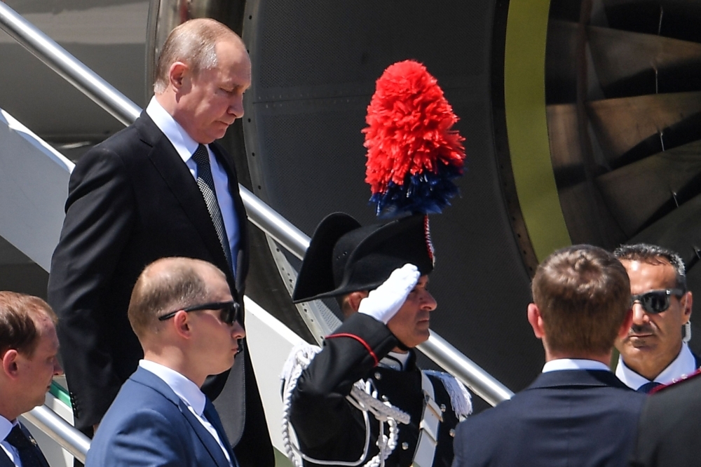 Russian President Vladimir Putin, left, exits the Russian presidential plane upon his arrival at Fiumicino airport for a one-day visit to the Vatican and Rome on Thursday. — AFP