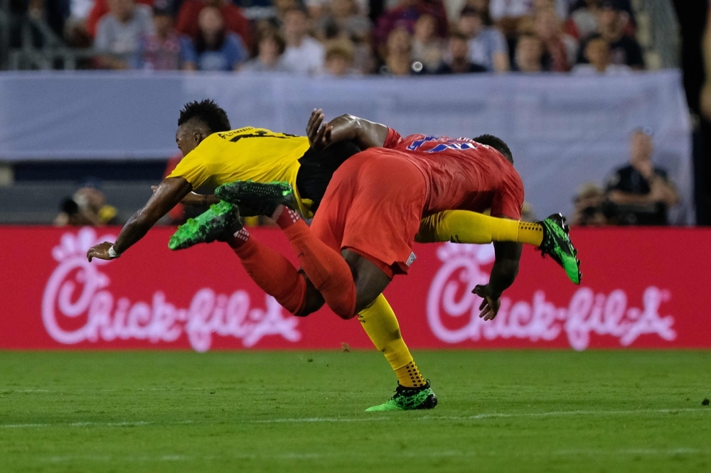 Junior Flemmings of Jamaica (L) battles for the ball with Jozy Altidore of USA during the 2019 Concacaf Gold Cup semifinal football match in Nashville, Tennessee, on Wednesday. — AFP