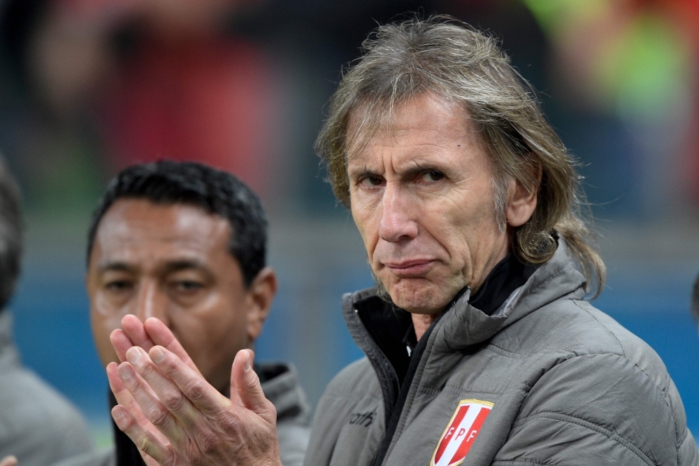 Peru's coach Argentine Ricardo Gareca applauds during the Copa America football tournament semifinal match between Peru and Chile at the Gremio Arena in Porto Alegre, Brazil, on Wednesday. — AFP