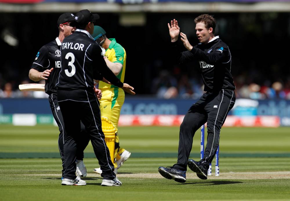 New Zealand's Lockie Ferguson celebrates taking the wicket of Australia's David Warner with teammates during the ICC Cricket World Cup match at Lord's, London, Britain. — Reuters