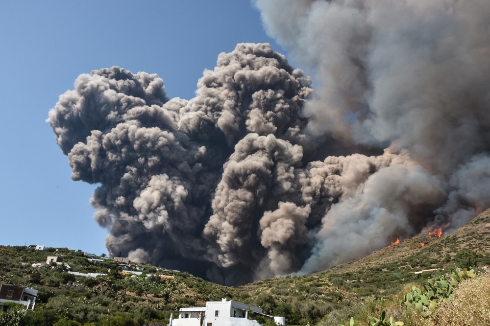 Smoke billows and spreads across the hillside after the Stromboli volcano erupted on Wednesday on the Stromboli island, north of Sicily. — AFP