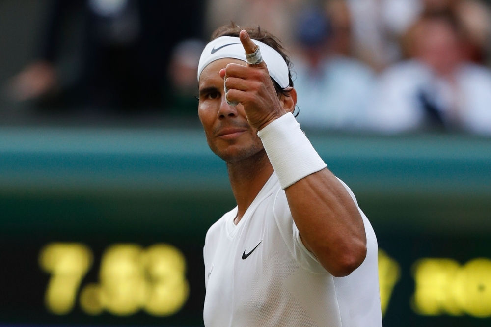 Spain's Rafael Nadal celebrates beating Australia's Nick Kyrgios during their men's singles second round match on the fourth day of the 2019 Wimbledon Championships at The All England Lawn Tennis Club in Wimbledon, southwest London, on Thursday. — AFP