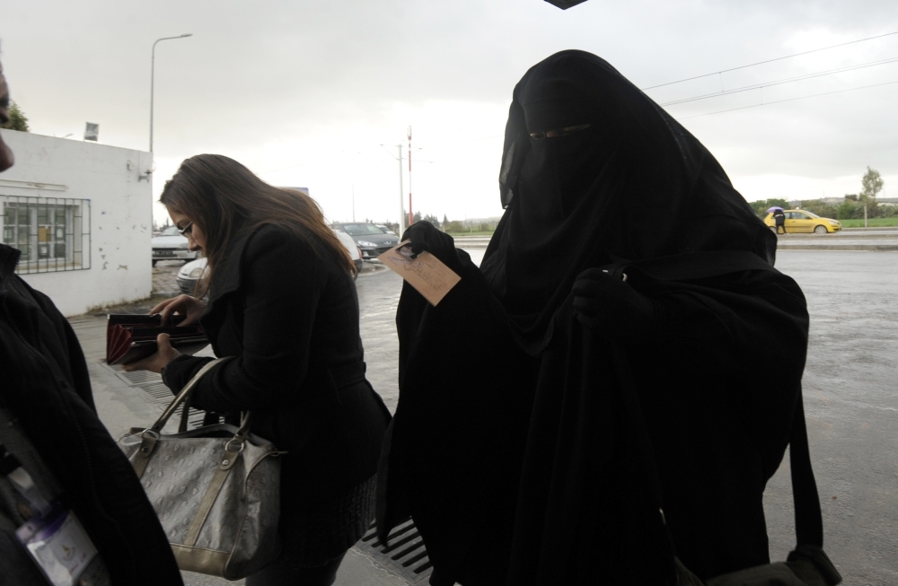 Tunisian students prepare to show identification before entering the University of Manouba's arts faculty outside Tunis in this Jan. 24, 2012 file photo. — AFP