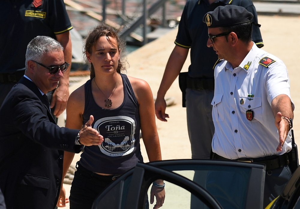 Carola Rackete, 31-year-old Sea-Watch 3 captain, disembarks from a Finance Police boat and is escorted to a car, in Porto Empedocle, Italy, in this July 1, 2019 file photo. — Reuters