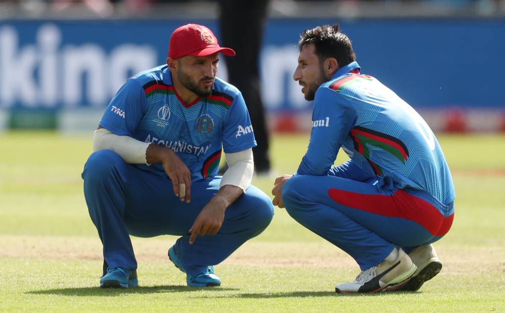 Afghanistan's Gulbadin Naib and Rahmat Shah discuss strategy during the ICC Cricket World Cup match against Pakistan at Headingley, Leeds, Britain on Saturday. — Reuters