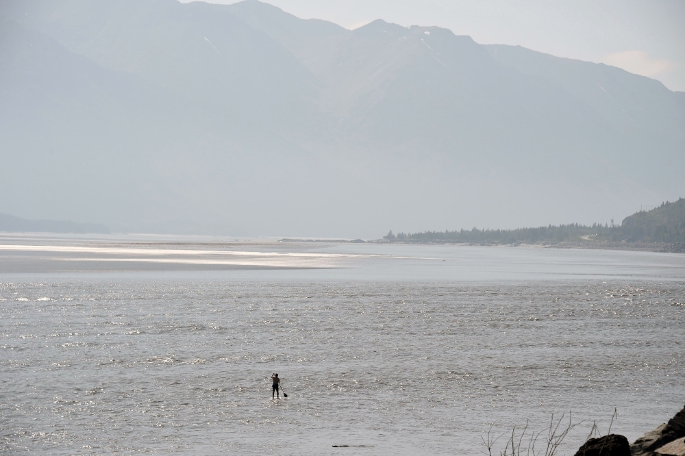 ANCHORAGE, AK - JULY 04: A man navigates the Turnagain Arm on a paddle board on July 4, 2019 south of Anchorage, Alaska. Alaska is bracing for record warm temperatures and dry conditions in parts of the state.   Lance King/Getty Images/AFP
== FOR NEWSPAPERS, INTERNET, TELCOS & TELEVISION USE ONLY ==
