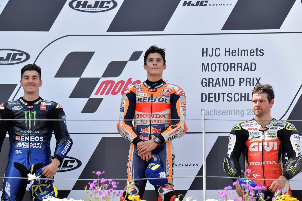 Winner Repsol Honda Team's Spanish rider Marc Marquez (C), second placed Monster Energy Yamaha' Spanish rider Maverick Vinales and third placed LCR Honda's British rider Cal Crutchlow (R) celebrate on the podium after winning the Moto GP Grand Prix Germany at the Sachsenring Circuit in Hohenstein-Ernstthal, eastern Germany, on Sunday. — AFP