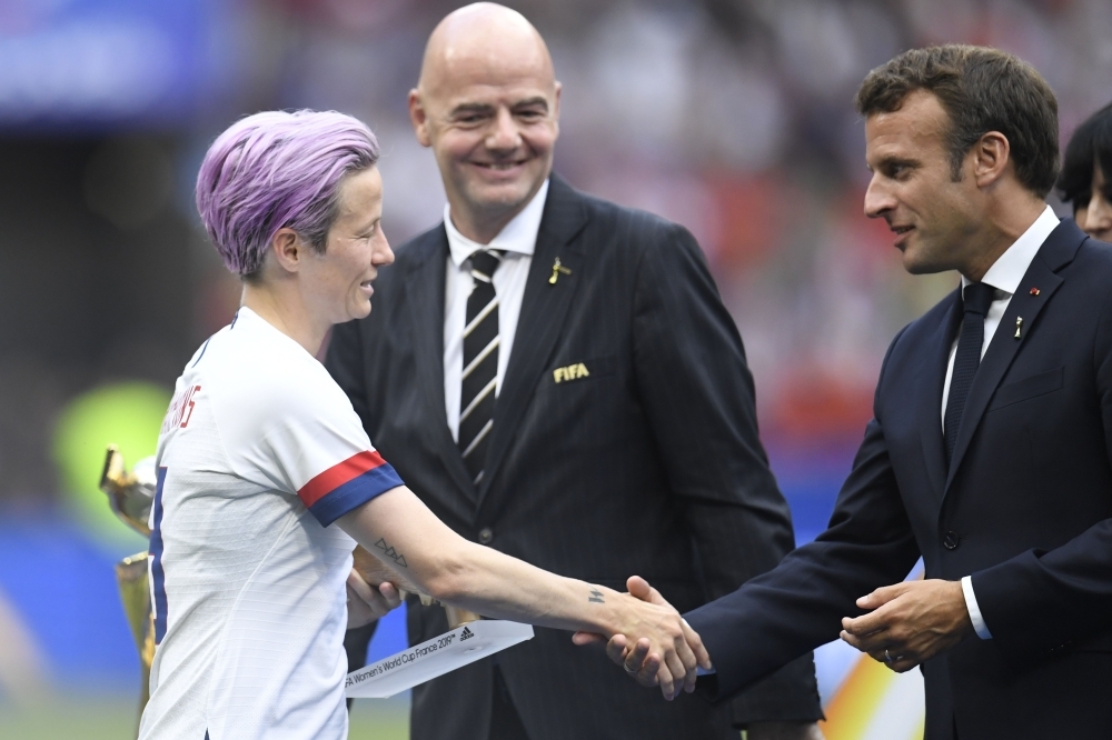 FIFA President Gianni Infantino (C) and French President Emmanuel Macron (R) present United States' forward Megan Rapinoe with the Golden Boot after the France 2019 Women’s World Cup football final match between USA and the Netherlands at the Lyon Stadium in Lyon, central-eastern France, on Sunday. — AFP