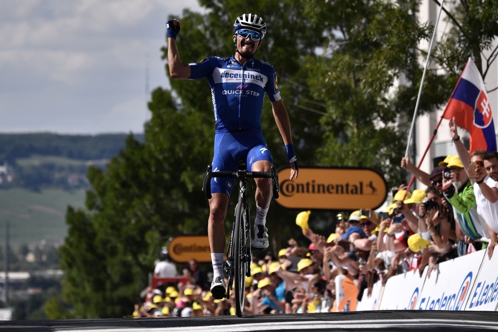 French rider Julian Alaphilippe celebrates his victory as he crosses the finish line of the third stage of the 106th edition of the Tour de France cycling race between Binche and Epernay, in Reims, on Monday. — AFP