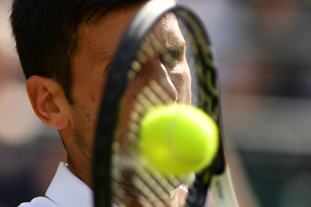 Switzerland's Roger Federer returns against Italy's Matteo Berrettini during their men's singles fourth round match on the seventh day of the 2019 Wimbledon Championships at The All England Lawn Tennis Club in Wimbledon, southwest London, on Monday. — AFP