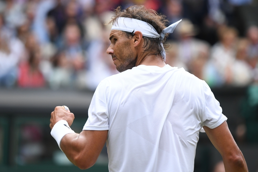 Switzerland's Roger Federer returns against Italy's Matteo Berrettini during their men's singles fourth round match on the seventh day of the 2019 Wimbledon Championships at The All England Lawn Tennis Club in Wimbledon, southwest London, on Monday. — AFP