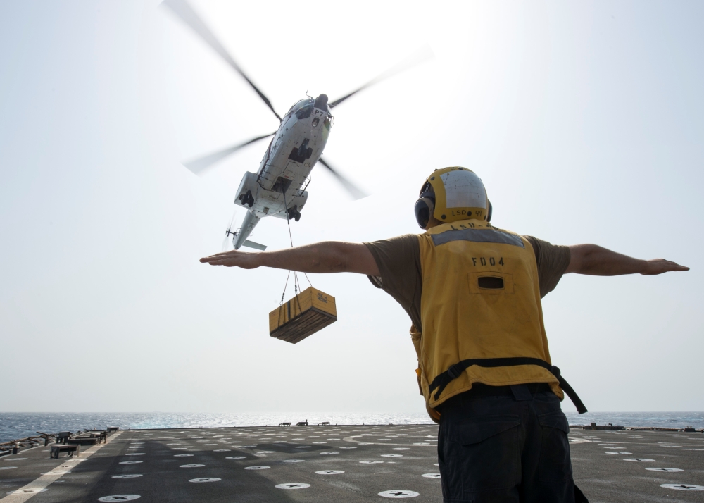 A US Navy sailor directs an SA-330J Puma Helicopter attached to Military Sealift Command dry cargo and ammunition ship USNS Cesar Chavez on the flight deck of amphibious dock landing ship USS Harpers Ferry during a vertical replenishment, in the Gulf of Aden, Arabian Sea, in this July 6, 2019 file photo. — Reuters