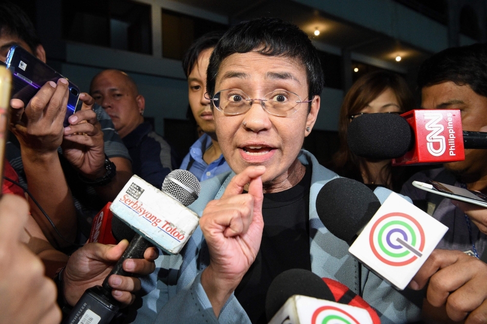  This file photo taken on February 13, 2019 shows Philippine journalist Maria Ressa speaking to the media as she arrives at the National Bureau of Investigation (NBI) headquarters after her arrest in Manila. -AFP
 