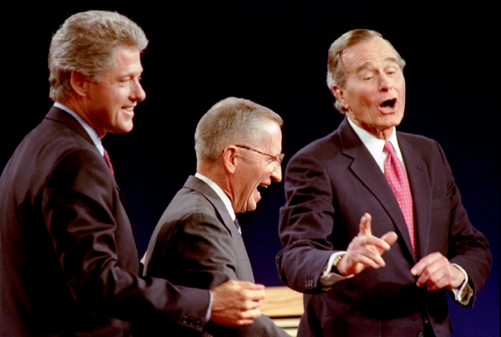 Democratic Presidential nominee Bill Clinton, left, Independent candidate Ross Perot, center, and President George Bush laugh at the conclusion of their Presidential debate in East Lansing, Michigan, in this Oct. 19, 1992 file photo. — Reuters