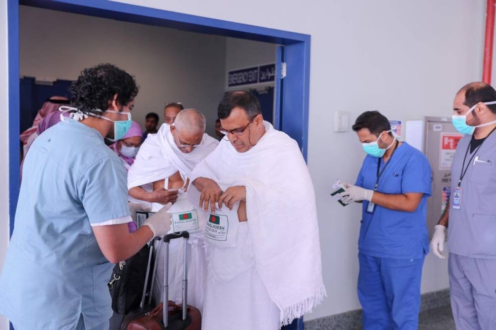 Staff at King Abdulaziz International Airport in Jeddah verify the health certificates of pilgrims arriving at the airport.