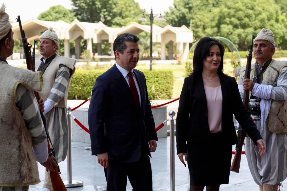 Vala Farid, right, the speaker of the Iraqi regional parliament, welcomes Masrour Barzani to attend a swearing-in ceremony as Prime Minister of Iraq's new Kurdistan Regional Government (KRG), in Arbil, the capital of northern Iraq's Kurdish autonomous region, on Wednesday. — AFP