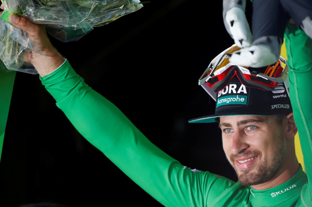 Bora-Hansgrohe rider Peter Sagan of Slovakia celebrates on the podium, wearing the green jersey, after winning the 175.5-km stage 5 from Saint-Die-des-Vosges to Colmar, on Wednesday. — Reuters